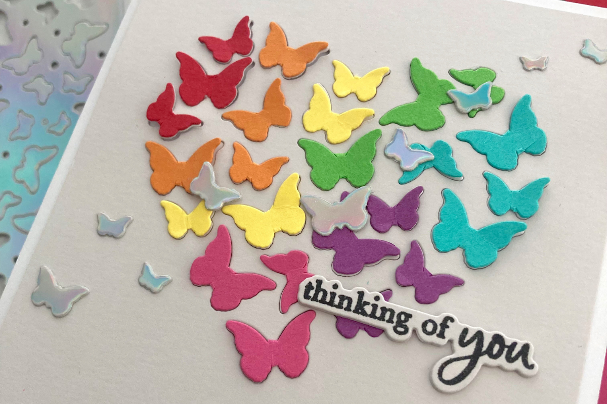 Cardstock Paper card made with rainbow and holographic butterflies from the 12x12 Cardstock Shop and the words "thinking of you"