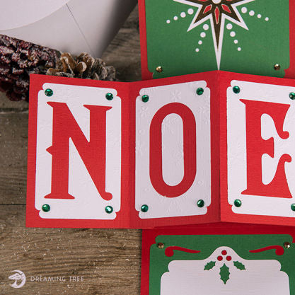 Cardstock kit with Christmas themed handmade card and decorative elements on a white background. Dreaming Tree Noel Twist Pop Card.