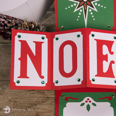 Cardstock kit with Christmas themed handmade card and decorative elements on a white background. Dreaming Tree Noel Twist Pop Card.