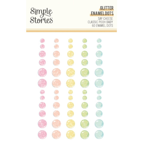 Set of glitter enamel dots by Simple Stories in various pastel colors on a white background.
