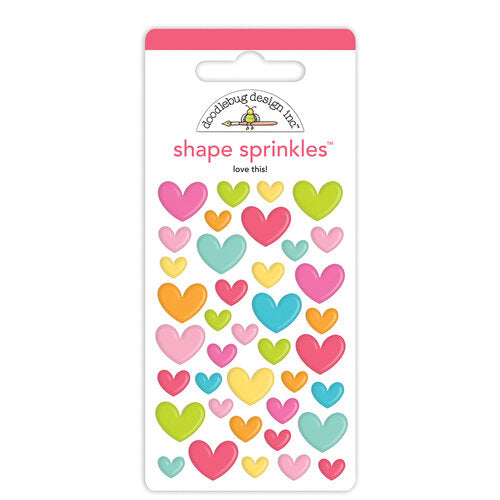 Self-adhesive enamel heart shapes. Shapes are self-adhesive and come in five different colors from Doodlebug Design.