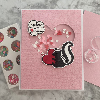 Skunk shaker card featuring Bazzill In the Pink and Shaker Bits