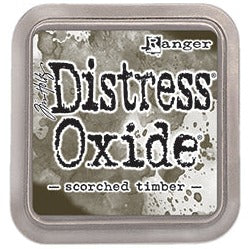 Dark Brown distress oxide ink is a blend of dye and pigment ink for paper projects. The water-reactive ink marbles when misted with water for a distressed ink look.