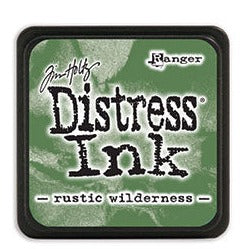 Dark olive green mini distress ink pad from Tim Holtz. Dye ink in a 1 inch ink pad. Stackable ink pads for distressing cardstock edges and mixed media projects.