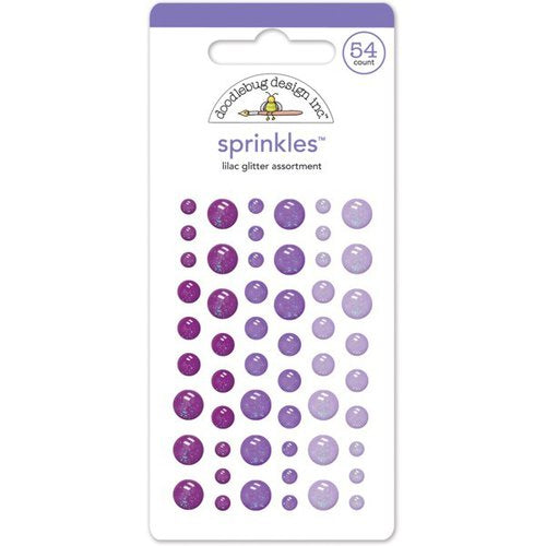 Fifty-four self-adhesive glitter enamel dots in small, medium, and large sizes. Colors include periwinkle, iris, and purple from Doodlebug Design.