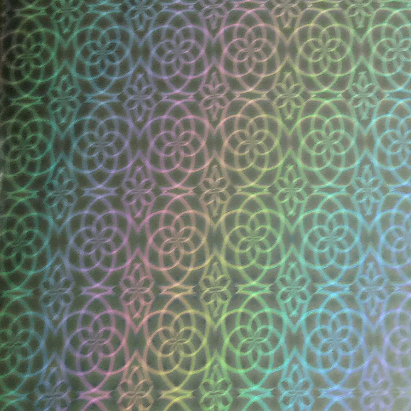 Close-up of holographic 12x12 cardstock with silver flower design