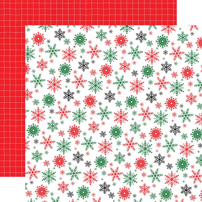 Double-sided 12x12 cardstock with red, green, and black snowflakes on a white background; the reverse is white pinstripe plaid on a red background.