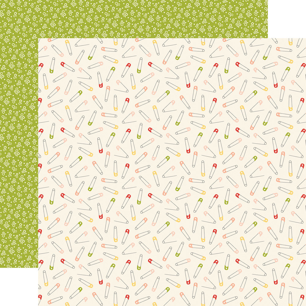 12x12 patterned cardstock with multi-colored safety pins on ivory background and petite white floral design on green reverse