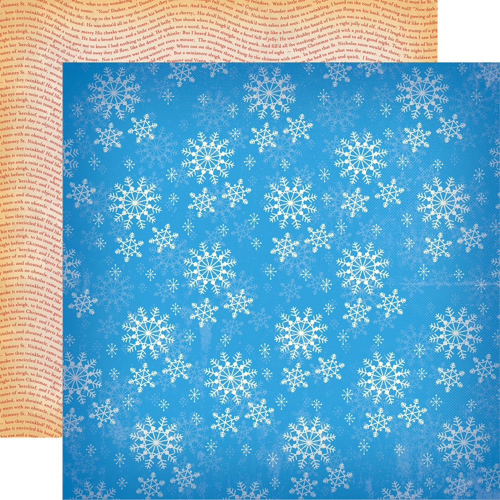 Double-sided 12x12 cardstock with multiple white snowflake shapes on bright blue background. The reverse is full of winter-inspired phrases written in a wave pattern in red on an off-white background.