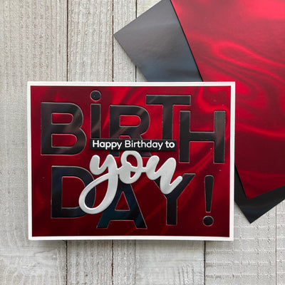 die cut card featuring Mirri Lava Holographic Cardstock in Red