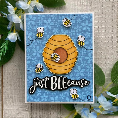 handmade card with stamped bees and blue flower background