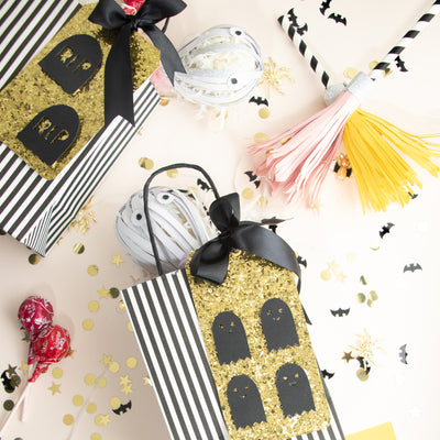 Gold glitter Halloween tag with black ghosts
